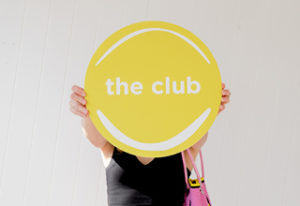 This is an image of Sarah Follent holding out the Club logo.