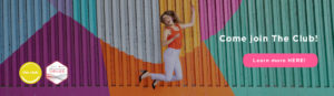 This is a image of Sarah Follent jumping for joy in front of a colourful wall.