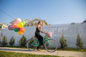 This is an image of Sarah riding a bike with balloons.