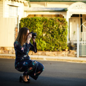 This is an image of Clarissa Rayward taking a photo for social media.
