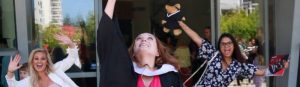 This is an image of Kiarah Grace Kelly throwing her graduation hat in the air.